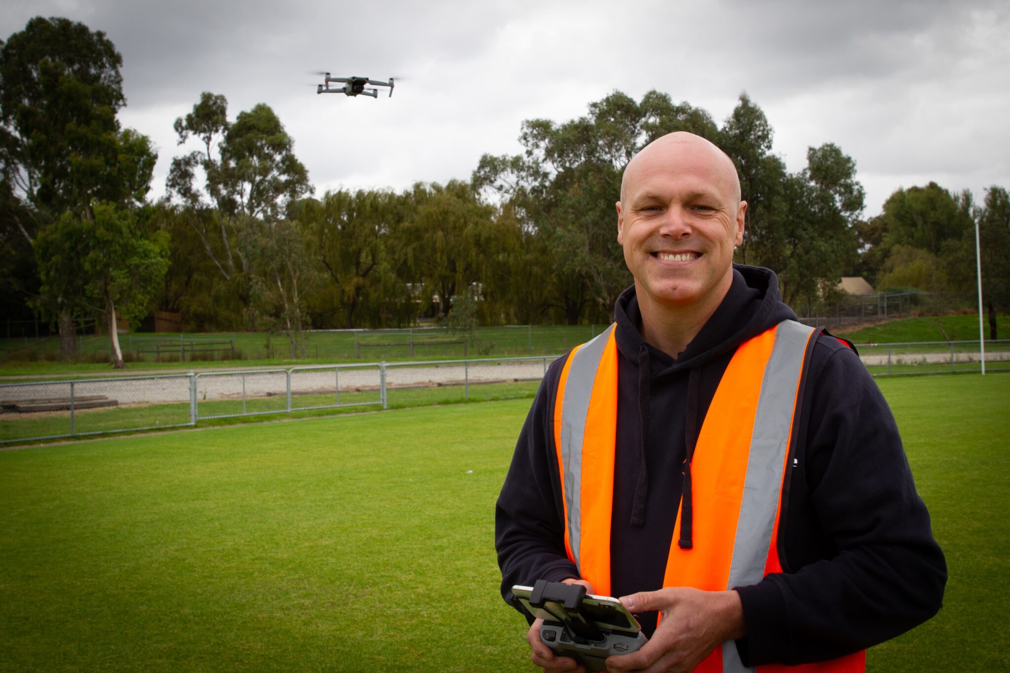 Professional drone photographer operating drone at construction site